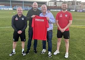 Jon newall is pictured on the field at Ossett Utd football club with representatives from the team.