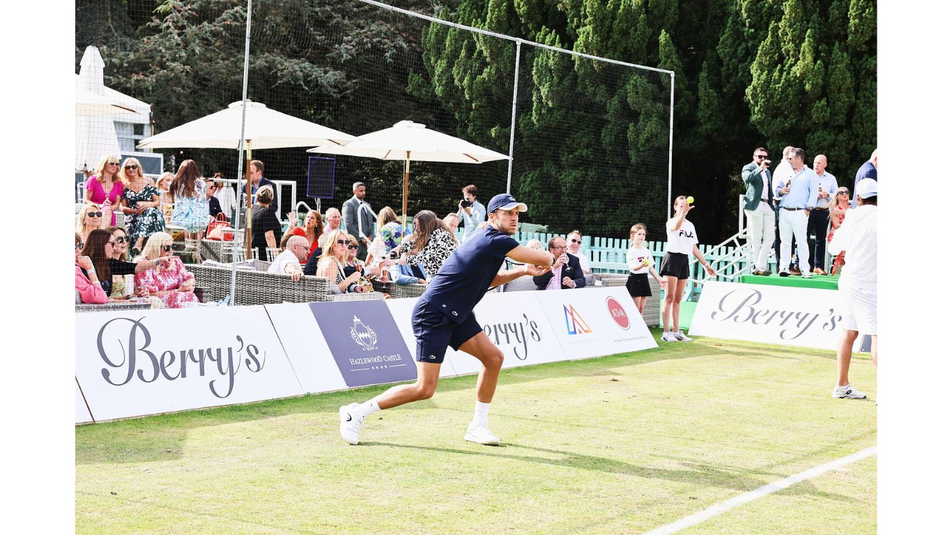 An action shot of a tennis player playing on court at Berry's Tennis event.