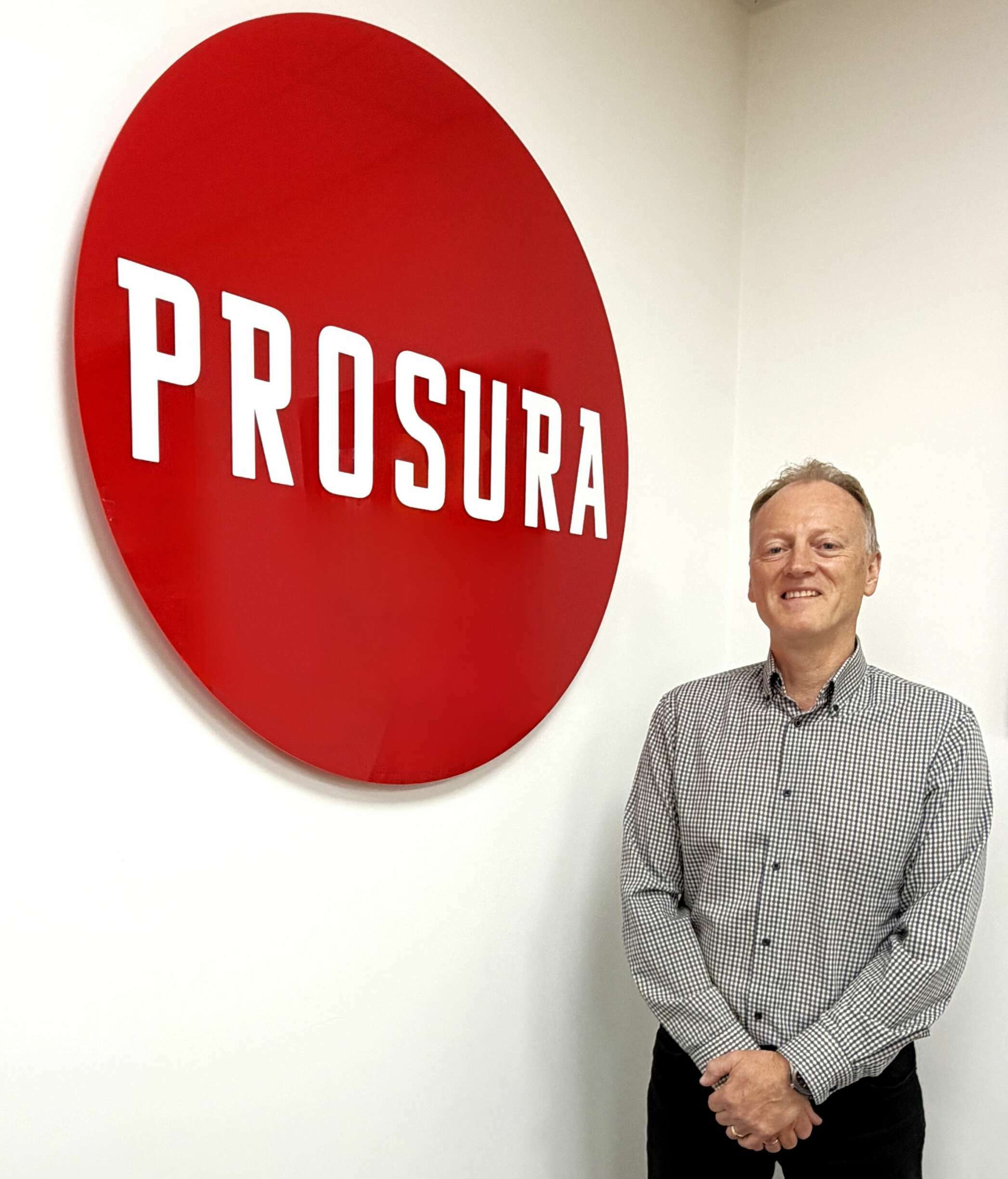 Eddie Hodgson is pictured in front of a Prosura logo.